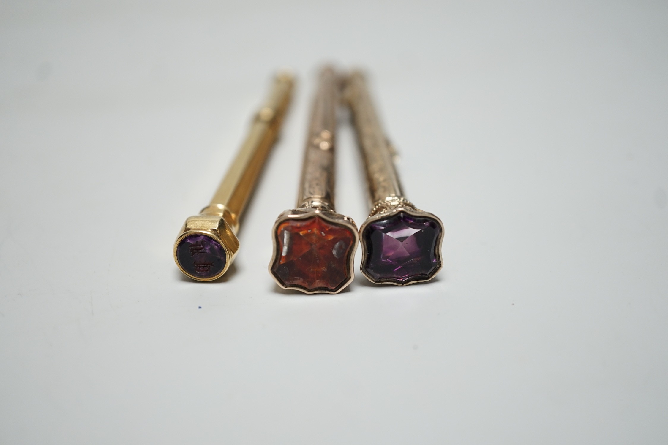 Three assorted yellow metal overlaid and gem set propelling pencils including Mordan